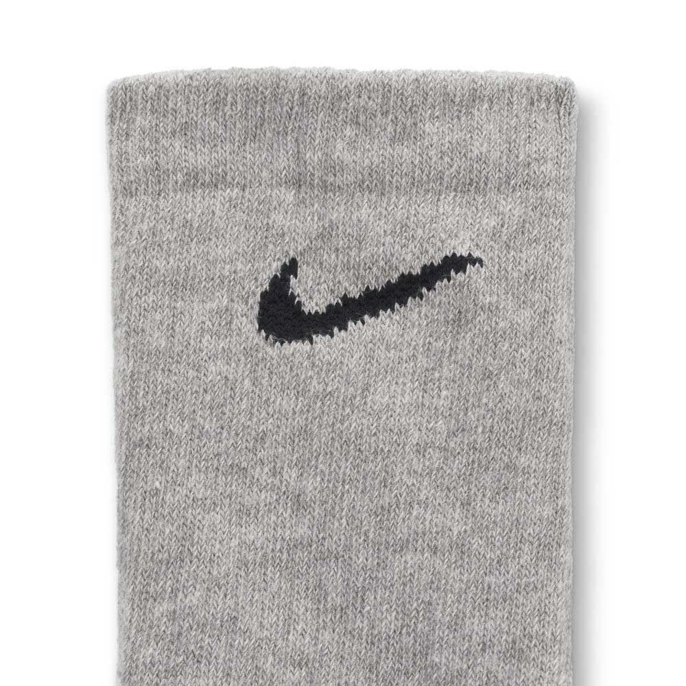 A close-up of a gray knitted fabric, likely from the SX7666964 Multi-Color Black Nike SB Socks Crew 6 Pack in Heather Gray, featuring a black Nike Swoosh logo embroidered near the top.