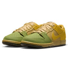 A pair of Saffron Quartz Pear Hatch Chili Dunk Low Pro IO0427300 Nike SB skateboarding shoes featuring green toes and front panels, with yellow Swooshes, heels, tongues, and laces, displayed against a white background.