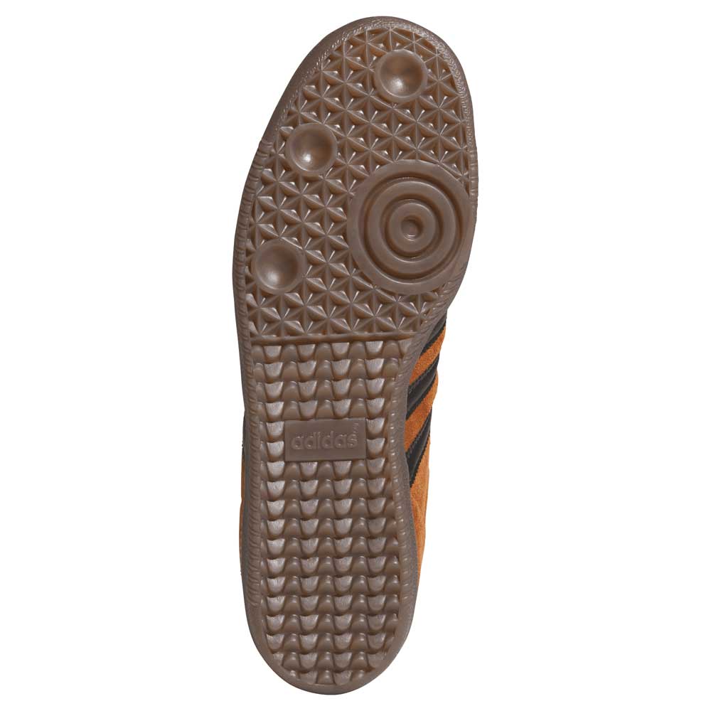 The image features the sole of the Samba ADV Brown Black HQ9286 Adidas Skateboarding Leather Suede Shoes, displaying a brown rubber tread with circular and triangular patterns, textured grip sections, and the Adidas logo.