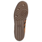 The image features the sole of the Samba ADV Brown Black HQ9286 Adidas Skateboarding Leather Suede Shoes, displaying a brown rubber tread with circular and triangular patterns, textured grip sections, and the Adidas logo.