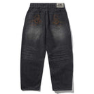 The Distressed Flat Black Relaxed Denim Jeans by Butter Goods feature a faded black finish, back embroidered orange scorpions, a white "Butter" label on the waistband, and are crafted from 100% cotton for comfort.