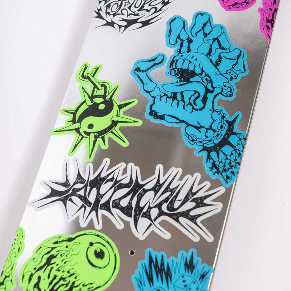 The Scribble Flash Feel Base 8.00in x 30.50in Santa Cruz Skateboards deck features colorful neon graphics—like a blue monster hand, green eyeball, graffiti text—on a reflective silver surface for standout style.