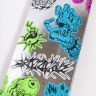 The Scribble Flash Feel Base 8.00in x 30.50in Santa Cruz Skateboards deck features colorful neon graphics—like a blue monster hand, green eyeball, graffiti text—on a reflective silver surface for standout style.