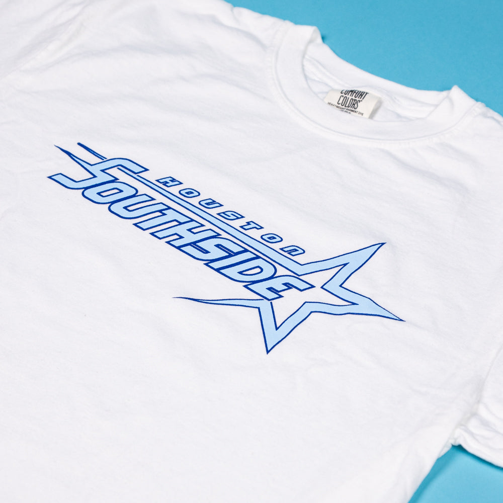 The Southside Sharp Star T-Shirt White Blue Night features "Houston Southside" in blue stylized text with a large star graphic, screenprinted and inspired by Southside Skatepark, shown on a blue background.
