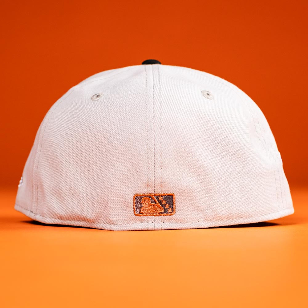 A Backlash Corpus Christi Hooks New Era 5950 Fitted Hat in white is shown from the back against an orange background, with a small orange and black rectangular patch near the bottom edge.