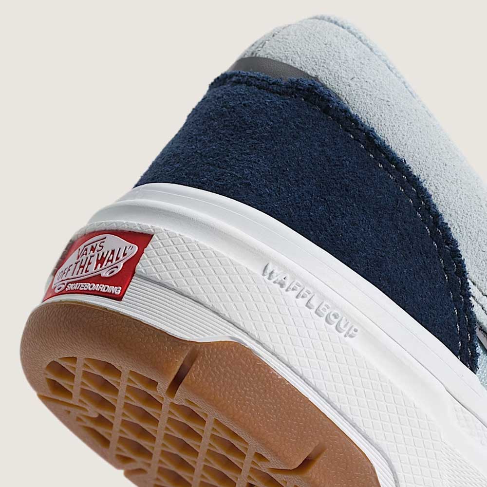 Close-up of the heel and sole of the Vans Skate Era Wafflecup Navy Blue Bell VN000EF0J4I1 suede rubber shoes, featuring blue suede, light gray fabric, a WaffleCup outsole with "WAFFLECUP" text, PopCush footbeds, and the red Off The Wall logo on the back.