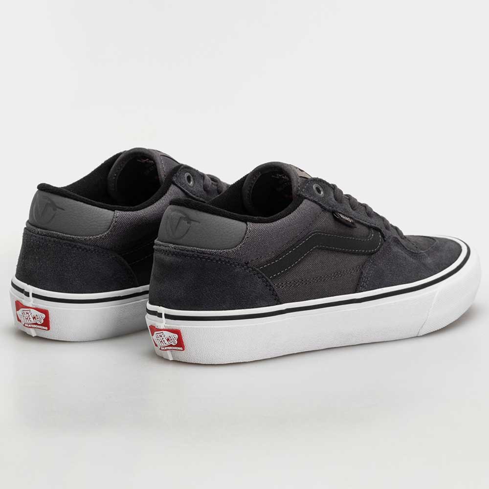 A pair of Skate Rowan Asphalt White VN0A5JICRP9 Suede Vans shoes with white soles and subtle heel logos, shown on a plain white background. A stylish skate shoe endorsed by Rowan Zorilla.