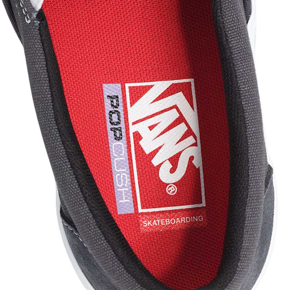 Close-up of the Vans Skate Slip On Pewter True White VN0A5FCA1N6 suede shoe in black, featuring a red insole with white Vans logo, POPCUSH, and SKATEBOARDING text printed on it, emphasizing enhanced durability and superior impact protection.