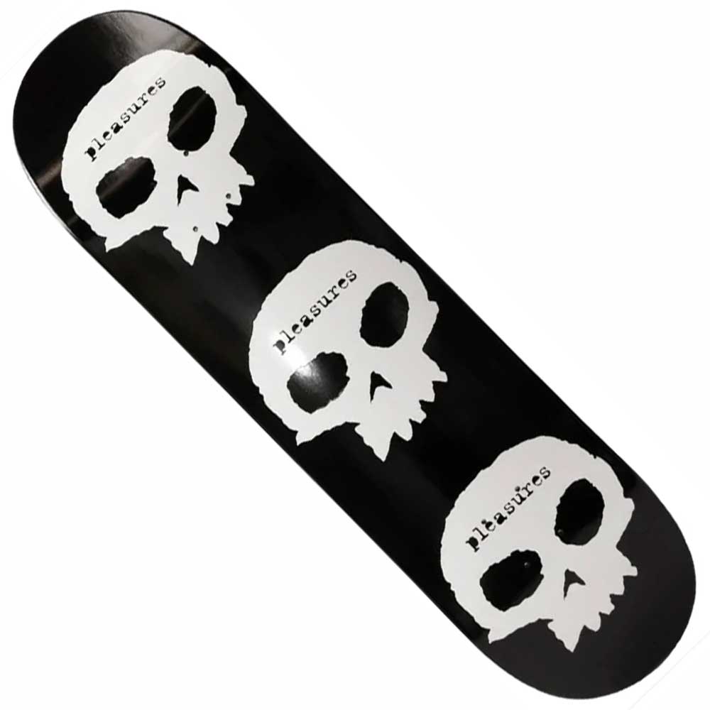 The Skulls 8.5 Pleasures x Zero Skateboards Deck features three white skulls stacked vertically on a black deck, each with "Pleasures" diagonally across the forehead—perfect for fans of bold, street-inspired designs.