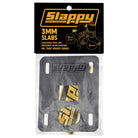 A pair of Slappy Slabs 3mm Black Low Risers for skateboards, with black rectangular pads, slotted holes, yellow branding, and packaged in clear plastic with a branded black-and-yellow header.