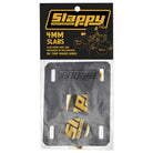 A pair of Slappy Slabs 4mm Black Low Risers for skateboards, featuring rectangular black pads with Slappy branding in yellow packaging, designed to help prevent wheel bite—visible through a clear plastic cover.