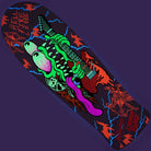 The Stranger Things Meek Slasher Eddie Reveal 10.1in x 31.13in Santa Cruz Skateboard Deck showcases a neon green and purple cartoon dinosaur rocking a red guitar, surrounded by blue lightning bolts, red flames, and the bold HELLFIRE logo at the top left.
