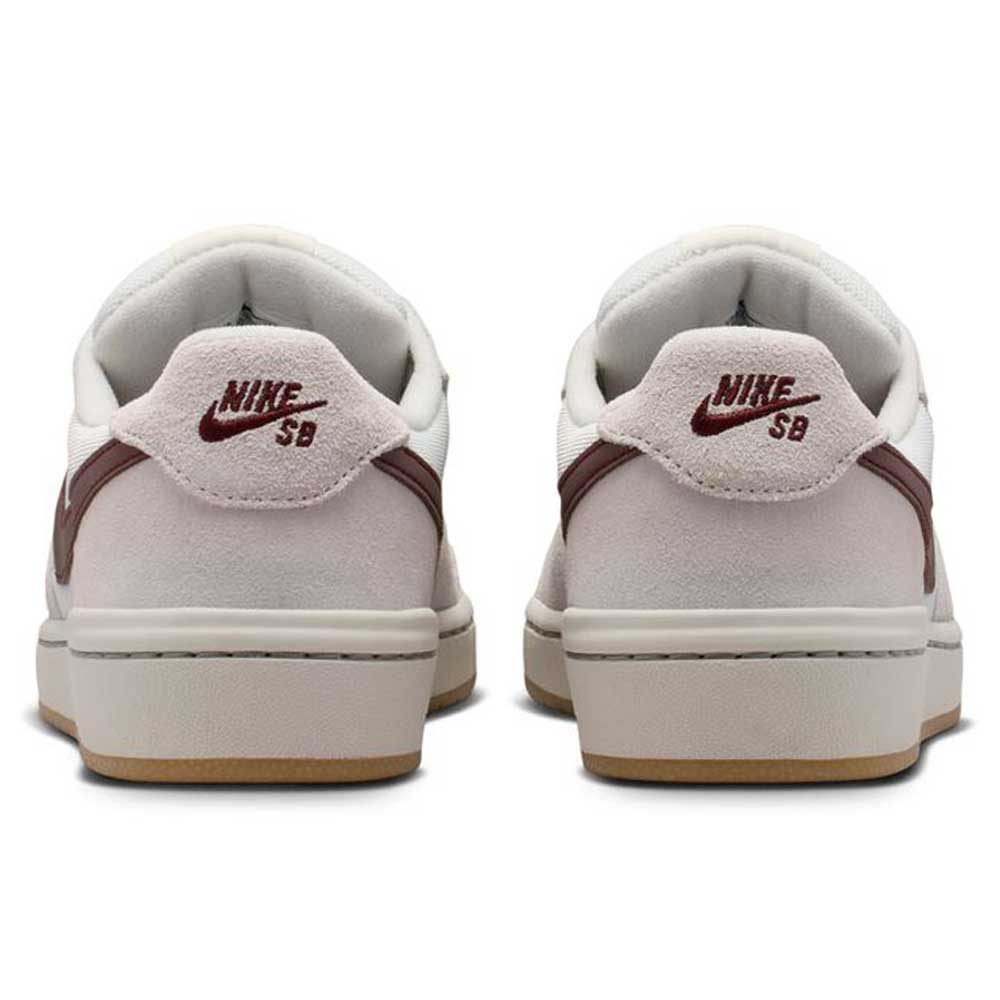 Back view of two Summit White Mystic Dates Code 58 IB0108102 Nike SB Skateboarding Suede Shoes, featuring off-white suede low-top silhouettes with dark red swoosh accents and logo embroidery on the heel tabs.