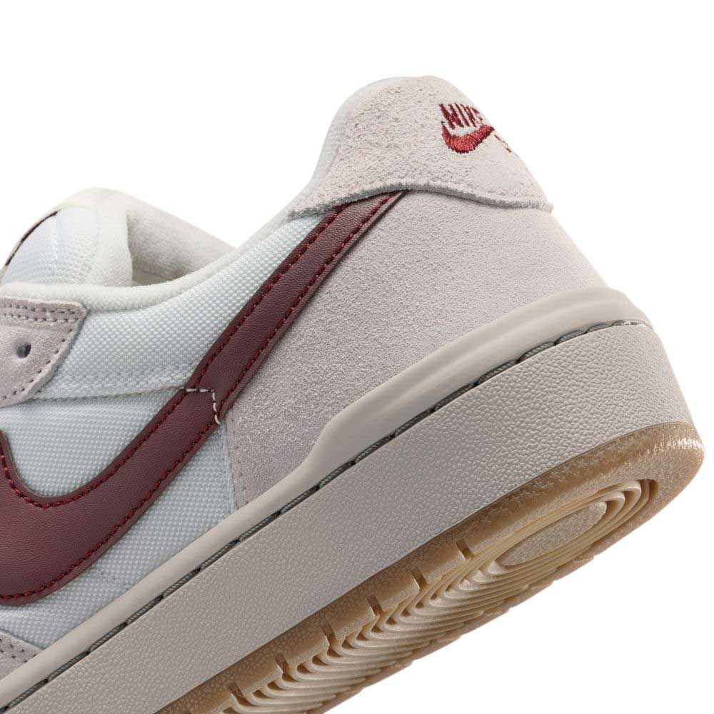 Close-up of the heel and side of a white and maroon Summit White Mystic Dates Code 58 IB0108102 Nike SB Skateboarding Suede Shoes with a durable gum rubber sole.