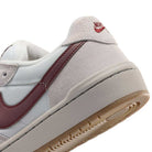 Close-up of the heel and side of a white and maroon Summit White Mystic Dates Code 58 IB0108102 Nike SB Skateboarding Suede Shoes with a durable gum rubber sole.