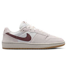 Summit White Mystic Dates Code 58 IB0108102 Nike SB Skateboarding Suede Shoes in off-white suede with a dark red swoosh and a gum rubber sole.