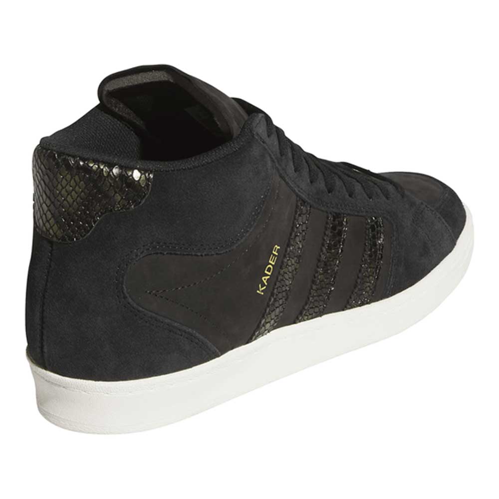 The adidas Superskate x Kader Shoes (JQ4413) feature a black suede and leather upper, textured details, signature Superskate stripes, “KADER” in gold, a white sole, and a snakeskin-style heel. Perfect for skateboarding in style.