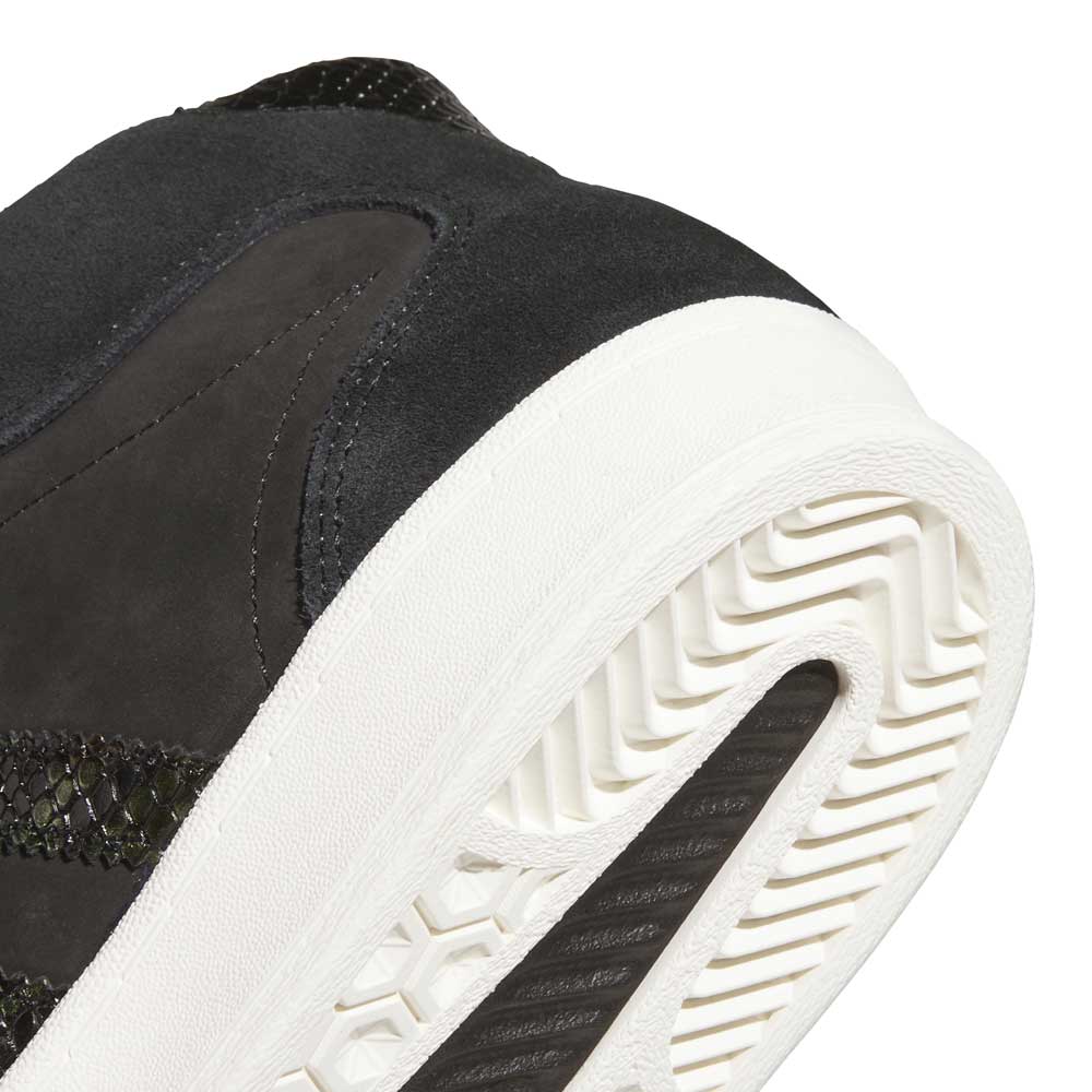 Close-up of the heel and sole of the Superskate x Kader Shoes JQ4413 in Core Black/Off White—crafted with suede and leather uppers, a white textured rubber outsole, and tread pattern, perfect for adidas Skateboarding shoes fans.