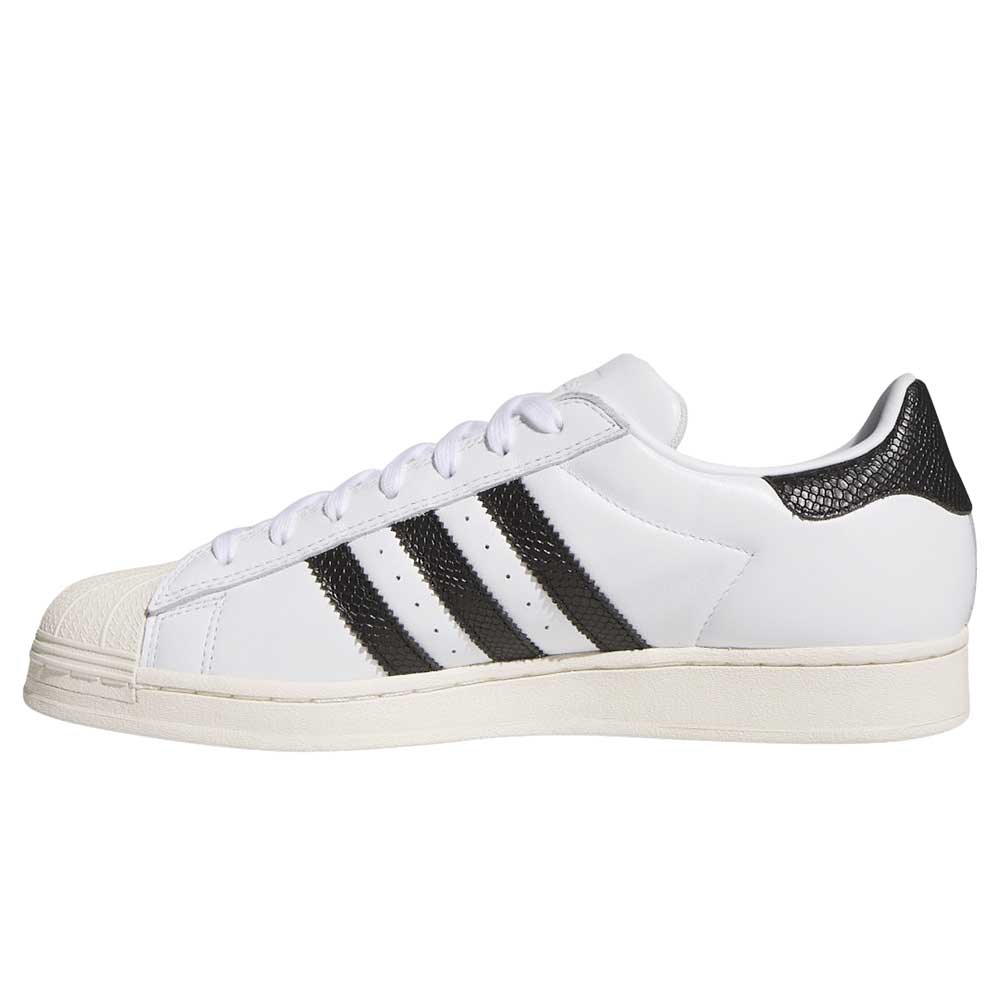 The adidas Superstar ADV White Black KI5727 skateboarding shoe features black stripes, white laces, a textured off-white rubber toe cap and sole, and a black textured heel panel. Photographed in profile, facing left. Suede and leather construction.