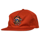 The Redux Dark Red Snapback by Krooked Skateboards features an embroidered front patch with a cartoon face, pink flowers, and "AROUND" above the design.