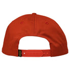 The image shows the back of the Redux Dark Red Snapback Krooked Skateboards cap, featuring an adjustable plastic closure and a small black and yellow Krooked Skateboards tag near the closure.