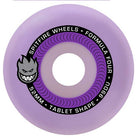 Introducing the Tablet Purple 52mm99A Spitfire Wheels Skateboard, featuring a lavender skateboard wheel with a black circular label that reads “Spitfire Wheels Formula Four 99DU 52MM Tablet Shape” alongside the iconic grinning flame logo—perfect for riders seeking high-performance Spitfire wheels in the classic 52mm 99A specification.