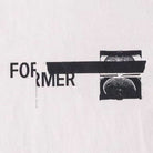 The Tape Crux Former Tee Bone features bold black FORMER text, partially concealed by a horizontal black bar and a stamped fingerprint against a crisp white backdrop. The bar artfully covers the O and part of the R, giving this premium jersey cotton vintage T-shirt an edgy, standout screen print design.