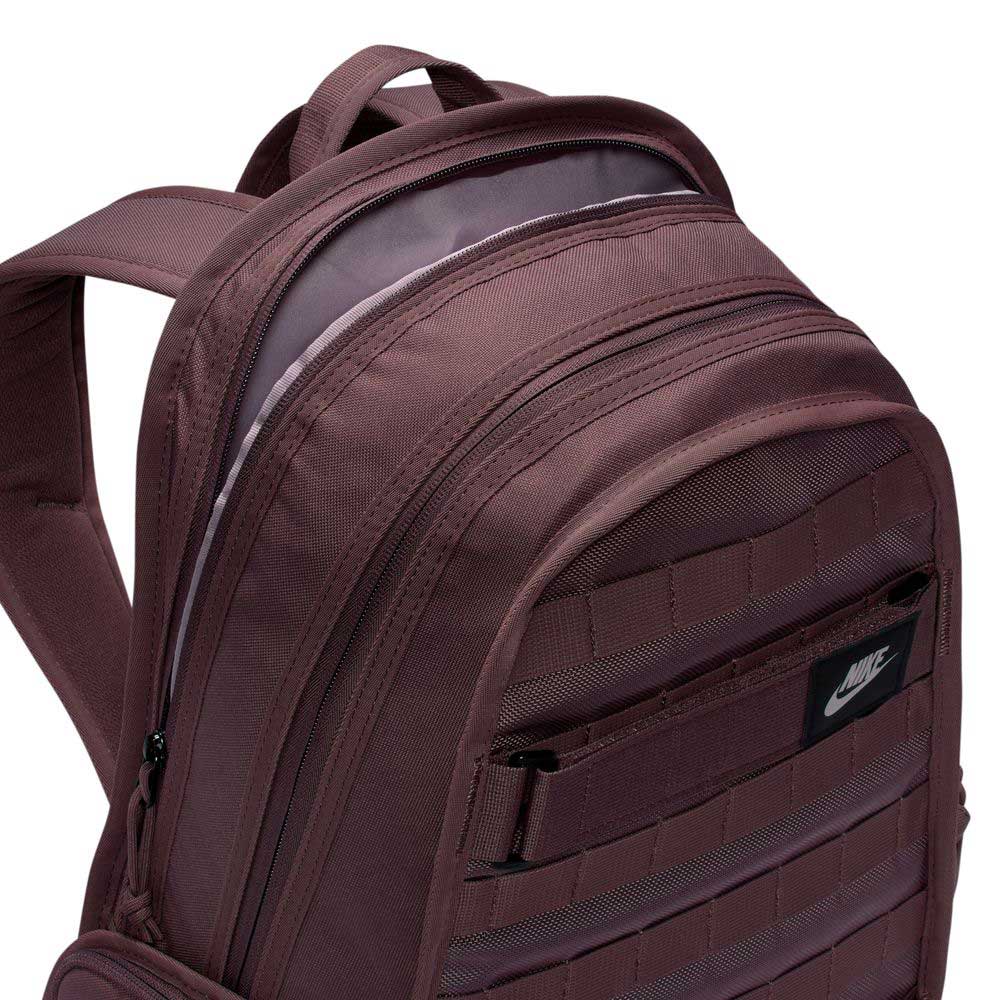 The Tattoo Black Light Violet FD7544502 Nike SB RPM Skate Backpack features multiple zip compartments, a black Nike logo patch on the front pocket, water-resistant design, and is shown from an angled, top-half view.