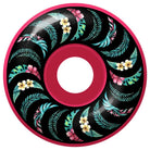 The Team Floral Pink 52mm99A Formula Four Spitfire Wheels Classic features a pink wheel with a black center, green leaves, and yellow and pink tropical flowers in a spiral pattern; available in 52mm size.