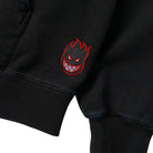 Team Lil Big Head Black Vintage Wash Pullover Hoodie Spitfire Wheels in a black vintage wash, featuring an embroidered red and white flame-headed character logo on the sleeve cuff.