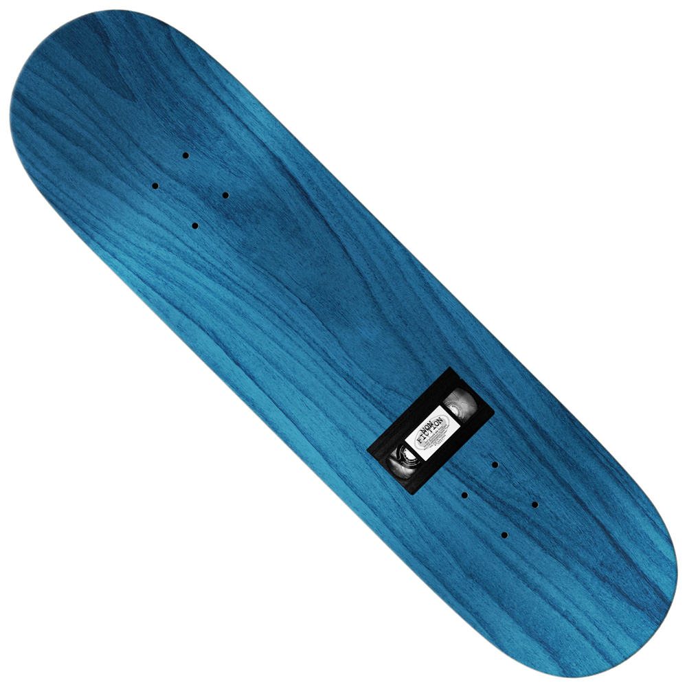 The Team Non-Fiction 8.12 Real Skateboards Deck is a blue wooden deck with visible wood grain, a small black rectangular metal plate at the center, and pre-drilled holes for mounting trucks.