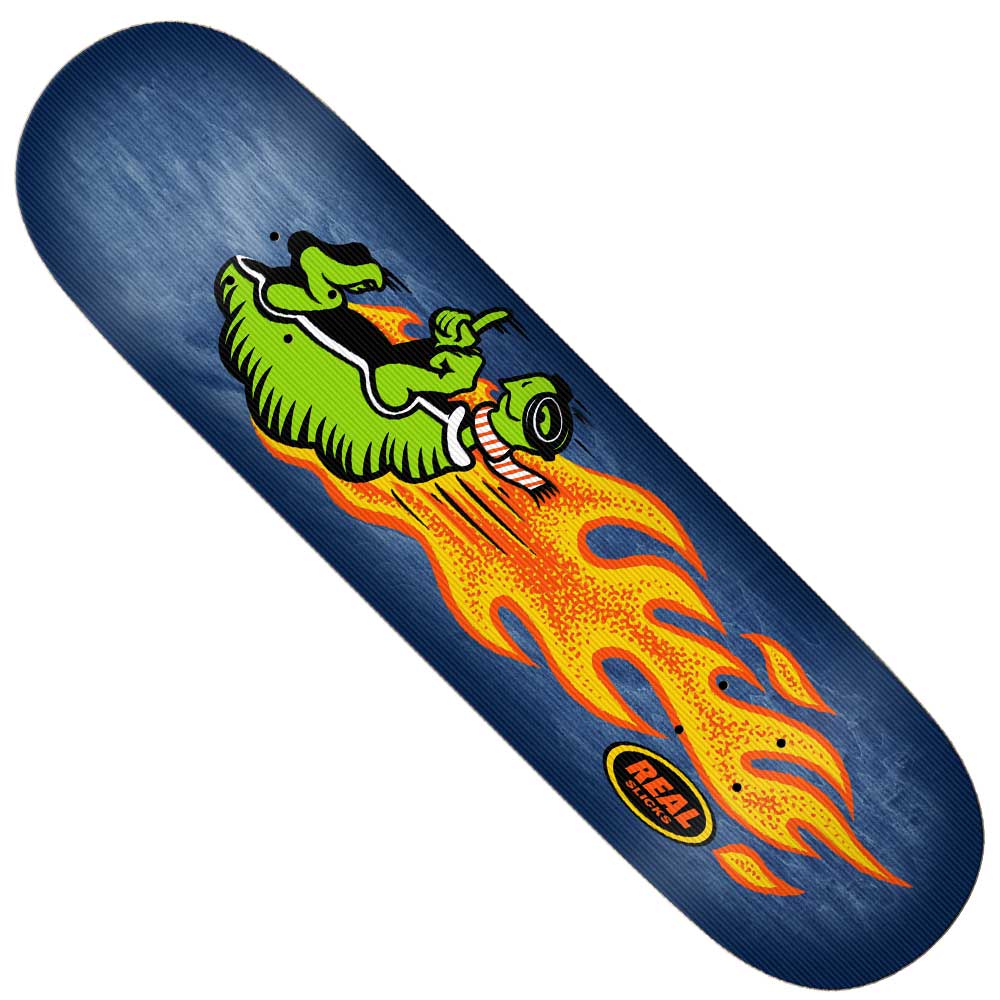 The Team Slick 8.5 Real Skateboards Deck features a green cartoon alligator in sunglasses riding orange flames on a dark blue background, with “REAL” in an oval near the bottom—ideal for Team Slick riders.