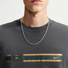 Charcoal gray Tee Black IW3134060 T-Shirt Nike SB Skateboarding crewneck featuring a gold and green horizontal graphic with a crest logo and a swoosh.