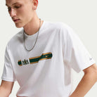 A Tee White IW3134100 T-Shirt Nike SB Skateboarding featuring a white jacquard skate jersey design with a horizontal gold and green stripe, an emblem, and a small logo.