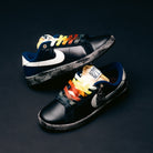 Two blue Zoom Tennis Classic x Rassvet IO9846400 Nike SB leather skateboarding shoes with sail-colored swooshes are set against a dark background. Each sneaker features rainbow-colored gradient laces arranged differently, while the comfortable insole ensures all-day support both on and off the board.