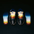 A pair of Zoom Tennis Classic x Rassvet IO9846400 Blue Void Sail Nike SB leather skateboarding shoes with colorful gradient insoles and multicolored laces are displayed on a black background. The insoles, featuring both Nike SB and Rassvet logos, highlight the signature comfort found in these limited-edition skateboarding sneakers.