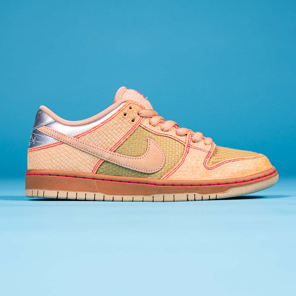 The READ BELOW the BUTTON RAFFLE Nike SB Som Tum Dunk Low features a woven peach, olive green, and beige upper with light pink swoosh, orange accents, and metallic silver heel; available via sneaker raffle at Southside Skatepark Skateshop.