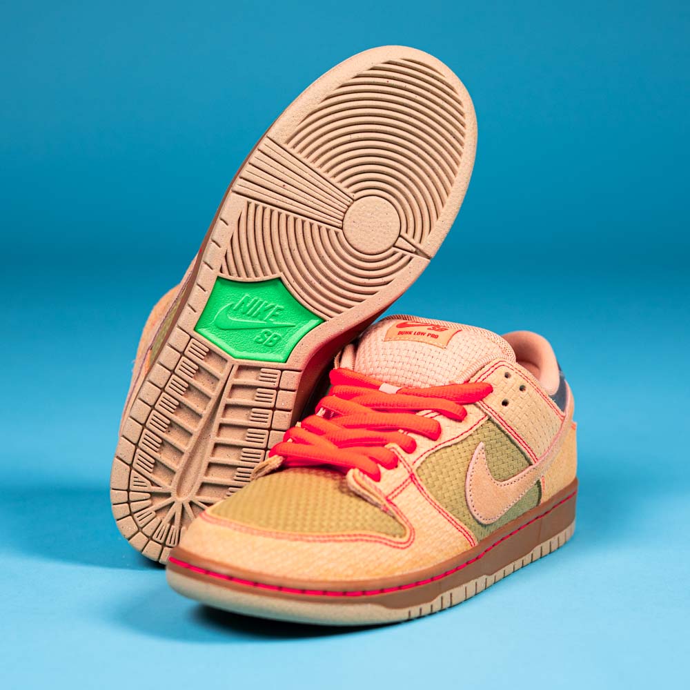 The READ BELOW the BUTTON RAFFLE Nike SB Som Tum Dunk Low features tan and peach hues, red laces, a green Nike logo on the sole, and textured details. Enter the raffle at Southside Skatepark Skateshop for your chance to buy.
