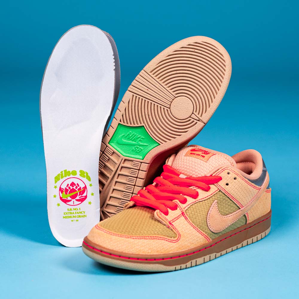 The READ BELOW the BUTTON RAFFLE Nike SB Som Tum Dunk Low sneakers in tan and light orange with red laces are shown—one upright, one on its side, plus a lotus graphic insole—against a blue background.