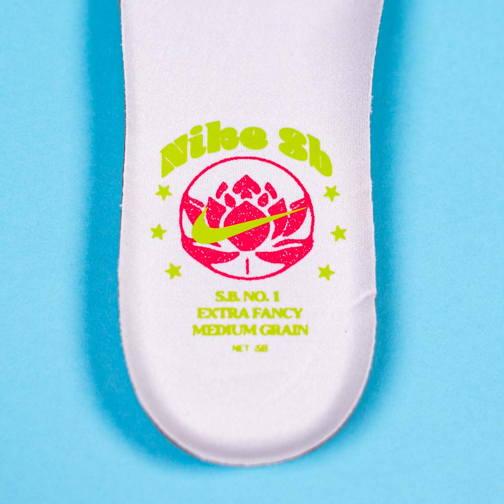 The READ BELOW the BUTTON RAFFLE Nike SB Som Tum Dunk Low features a white insole with neon green and pink graphics—lotus flower, stars, Nike swoosh, and Southside Skatepark Skateshop branding on blue—ideal for sneaker raffles.