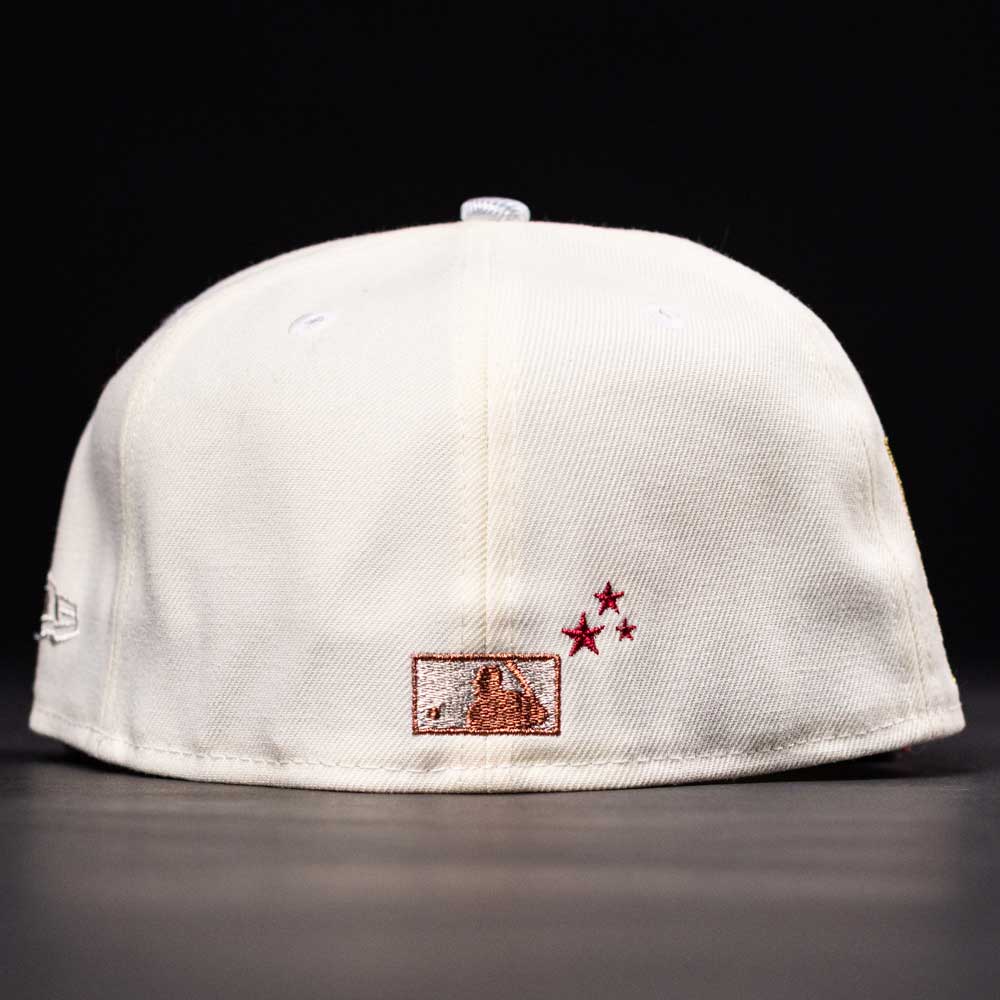 The Final Hour New Era Hat 5950 Fitted NEW YEAR DROP in white, shown from the back with a small embroidered mountain patch and three red stars beside it. Black background.