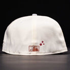 The Final Hour New Era Hat 5950 Fitted NEW YEAR DROP in white, shown from the back with a small embroidered mountain patch and three red stars beside it. Black background.