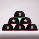 Six black and red The Last Call New Era Hat 5950 Fitted NEW YEAR DROP caps, each with a gold and white H star logo, are stacked in a pyramid on a plain white background—perfect for your last call pick.