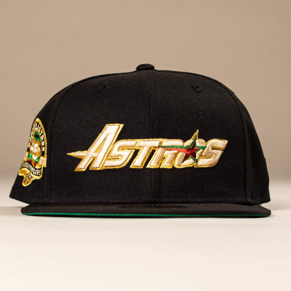 The La Morenita Black 45th Houston Astros New Era 5950 Fitted Hat features “Astros” embroidered in gold and white, a red and green star, and a vibrant side patch.