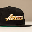 The La Morenita Black 45th Houston Astros New Era 5950 Fitted Hat features "Astros" embroidered in gold and white with a star graphic, set against a neutral background.