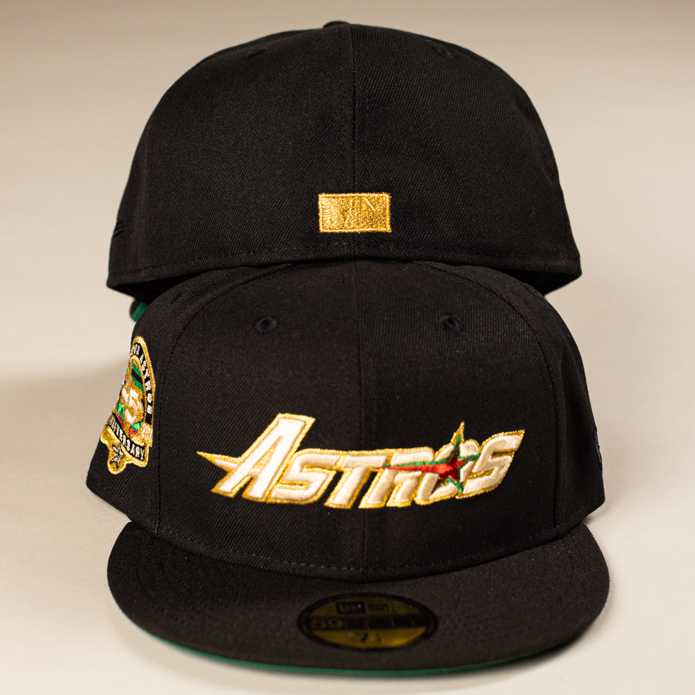 Two La Morenita Black 45th Houston Astros New Era Hat 5950 Fitted hats: the front hat has a gold embroidered Astros logo and colorful side patch, while the back displays a small gold rectangle on its rear panel.
