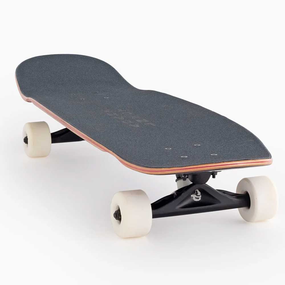 The Tugboat Atmosphere Landyachtz Complete Skateboard, featuring a compact black deck and white wheels, is shown on a white background—angled to highlight its grip tape and trucks—perfect for smooth city cruising or urban carving.