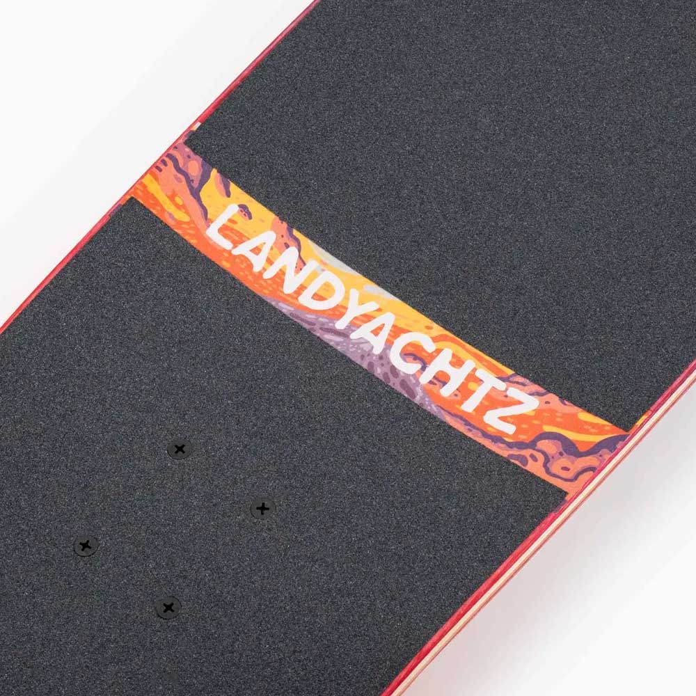 Close-up of the Tugboat Nightfall Landyachtz Complete Skateboard, featuring a Canadian maple deck with black grip tape, a colorful center strip displaying "LANDYACHTZ" in white, and a red-edged cruiser design.