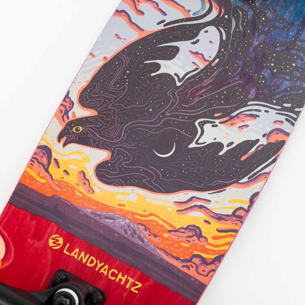 Close-up of the Tugboat Nightfall Landyachtz Complete Skateboard deck, crafted from Canadian maple with vivid art of a black bird over a sunset. Yellow LANDYACHTZ lettering appears near the bottom; Hawgs wheels finish the design.