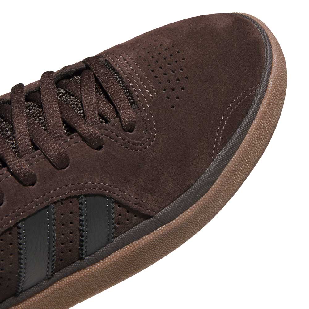 Close-up of the Tyshawn HQ4740 Brown Gum Adidas Skateboarding Suede Shoes with perforated details, brown laces, black leather stripes, and a textured rubber sole—premium skate style.
